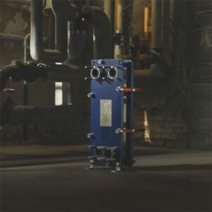 Freestanding Alfa Laval plate heat exchanger in dimly lit industrial plant room – supplied by AEL Heat Exchangers UK